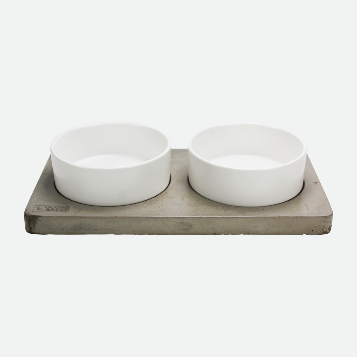 White ceramic pet bowls on concrete base